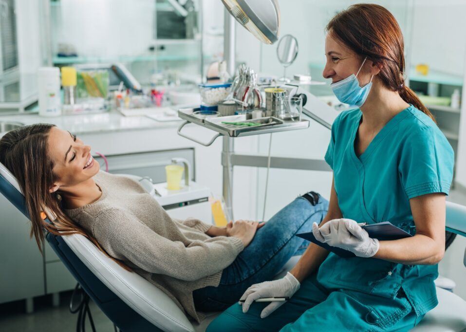 dental assistant smiling at a patient in a patient chair